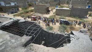 A big hole is seen on a rooftop of a house suspected to have been damaged in Indian drone attack. (AP: Fareed Khan)