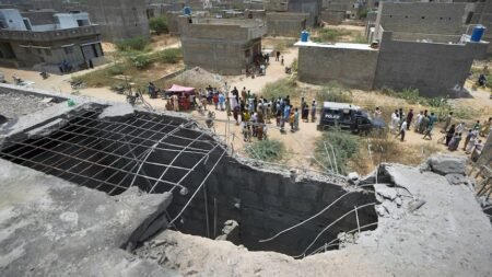 A big hole is seen on a rooftop of a house suspected to have been damaged in Indian drone attack. (AP: Fareed Khan)