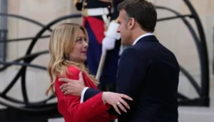 Paris summit Macron Meloni embrace sparks debate